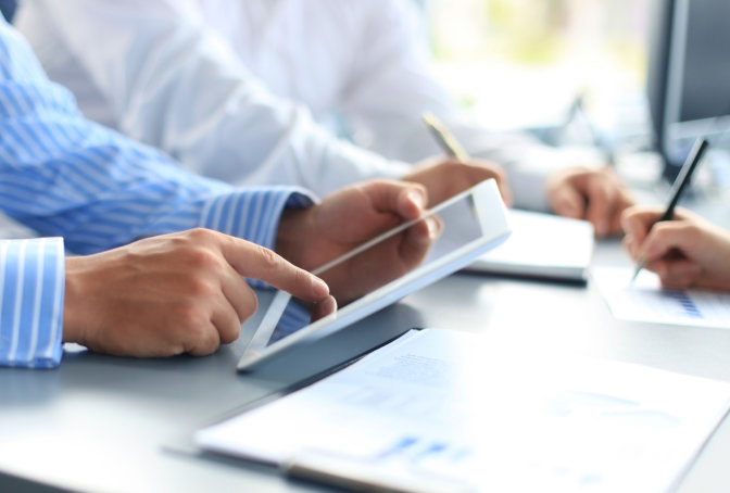 Reviewing coverage figures on a tablet and printed comparisons